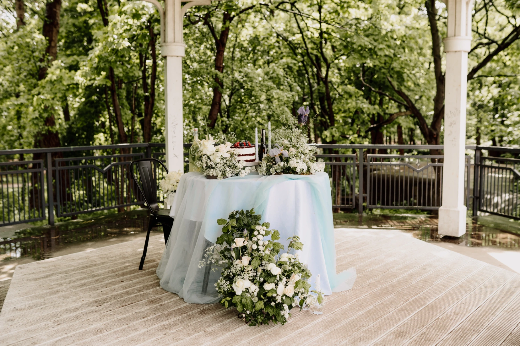 Stolik ceremonialny z tortem i kompozycjami kwiatowymi